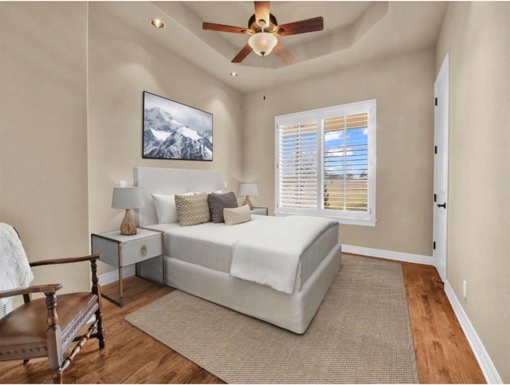 11918 Riek Road Krum, TX 76249 - Photo 23 of 39 a spacious bedroom with a bed a couch and a window