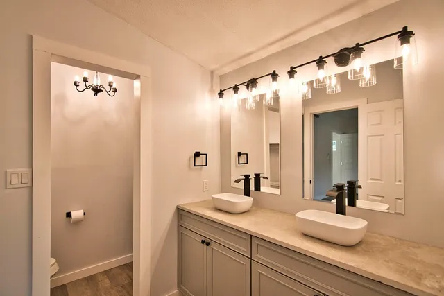 a bathroom with a double vanity sink and mirror
