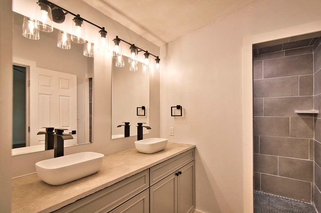 425 Post Hill Street Mason, TX 76856 - Photo 16 of 18 a bathroom with a double vanity sink and mirror