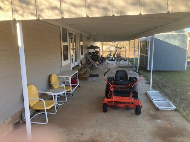 425 Post Hill Street Mason, TX 76856 - Photo 6 of 18 a car parked in patio of a house