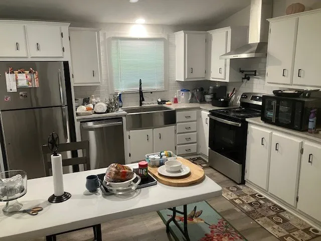a kitchen with a sink stove and cabinets
