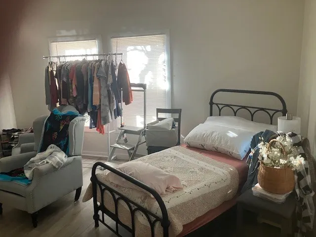 a bedroom with double bed and a window