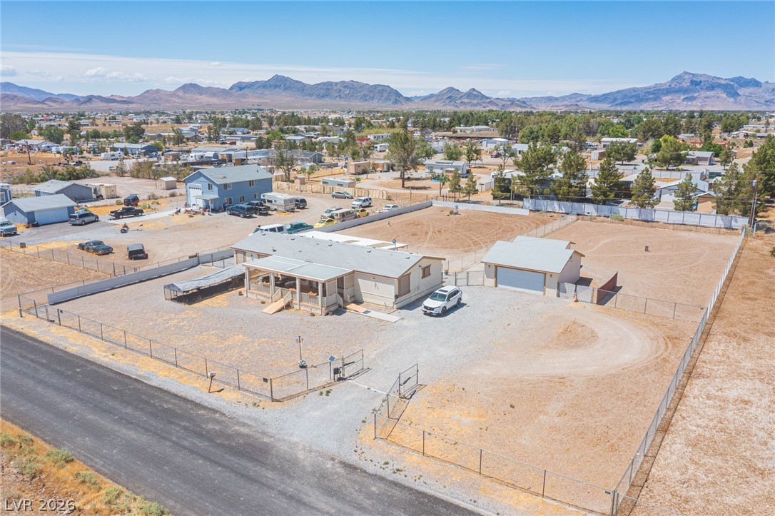 3200 Maple Road Pahrump, NV 89048 - Photo 47 of 53 Secure, fenced property offering ample space and a functional outbuilding amidst mountain vistas.