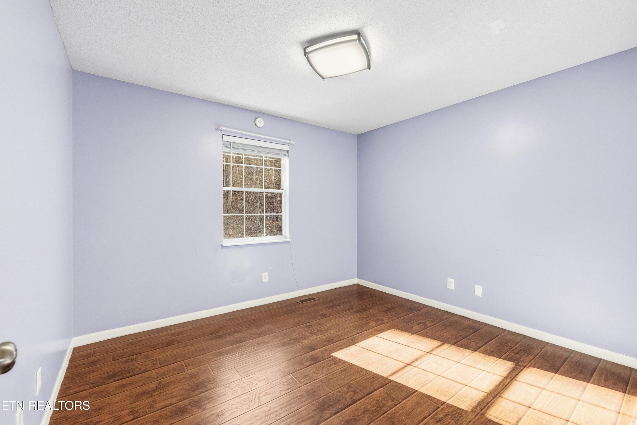 3214 Long Hollow Road Powell, TN 37849 - Photo 14 of 23 an empty room with wooden floor and windows