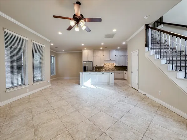 a view of a kitchen with kitchen island stainless steel appliances refrigerator sink microwave and cabinets