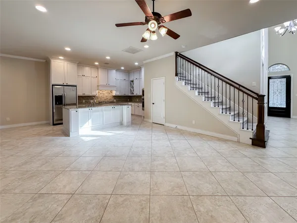 a view of a kitchen with kitchen island stainless steel appliances counter top space a sink a window and kitchen view