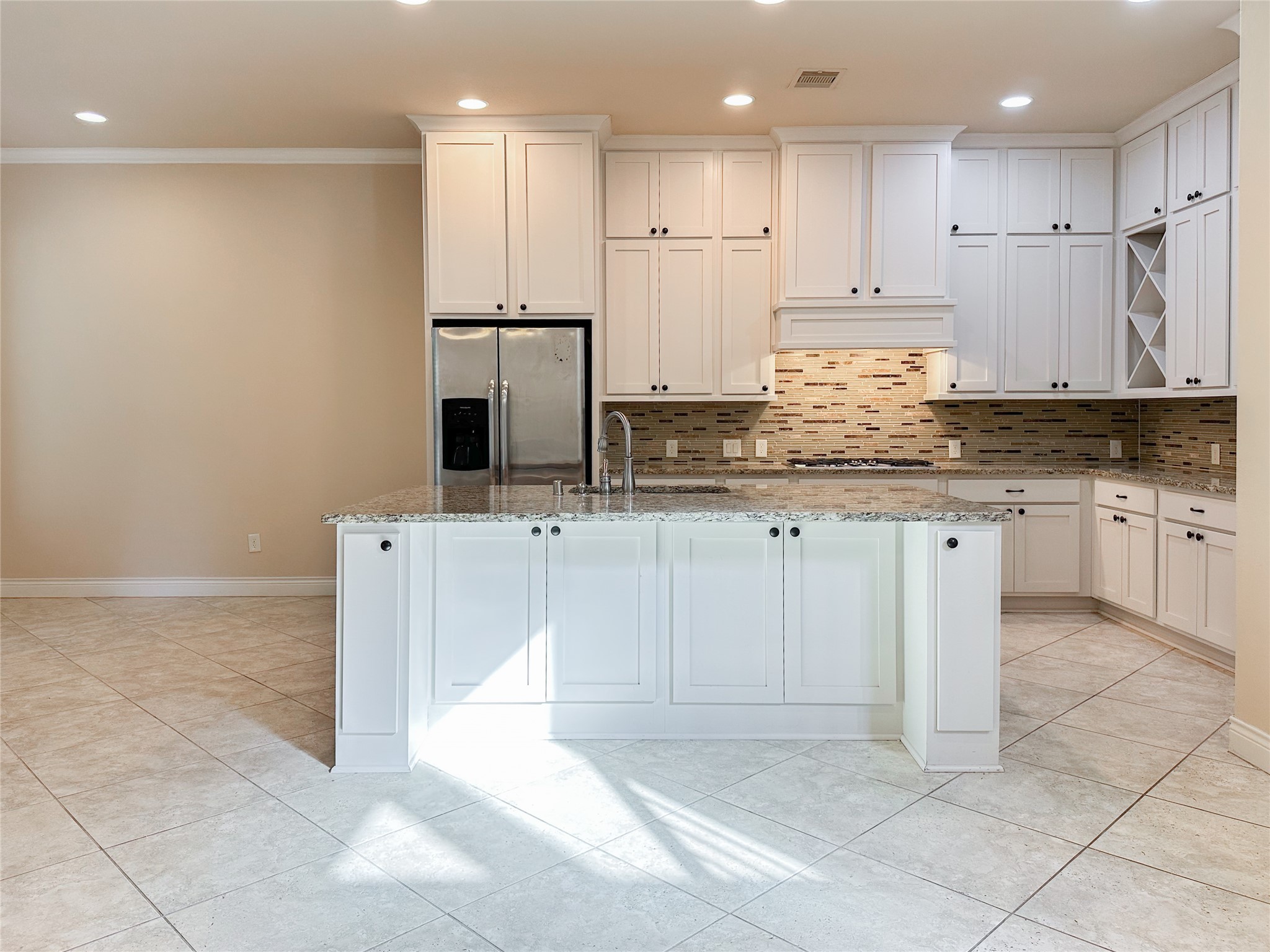23 Jonquil Place Tomball, TX 77375 - Photo 14 of 50 a kitchen with granite countertop a sink a stove a refrigerator and white cabinets