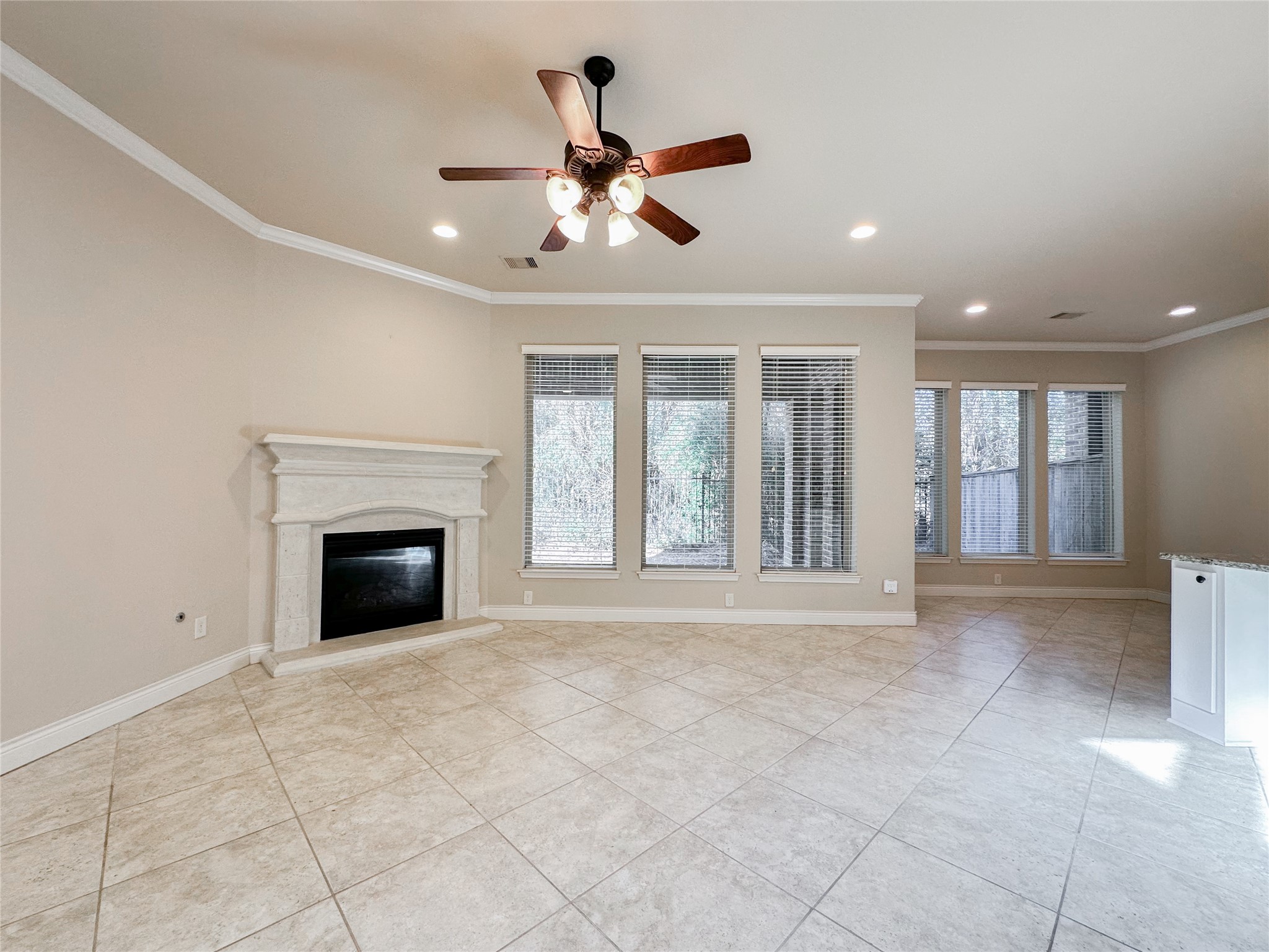 23 Jonquil Place Tomball, TX 77375 - Photo 17 of 50 a view of an empty room with chandelier fan and fire place