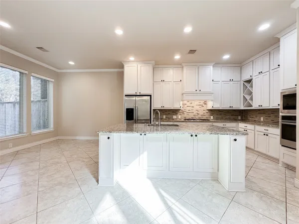 a kitchen with stainless steel appliances granite countertop a sink and cabinets