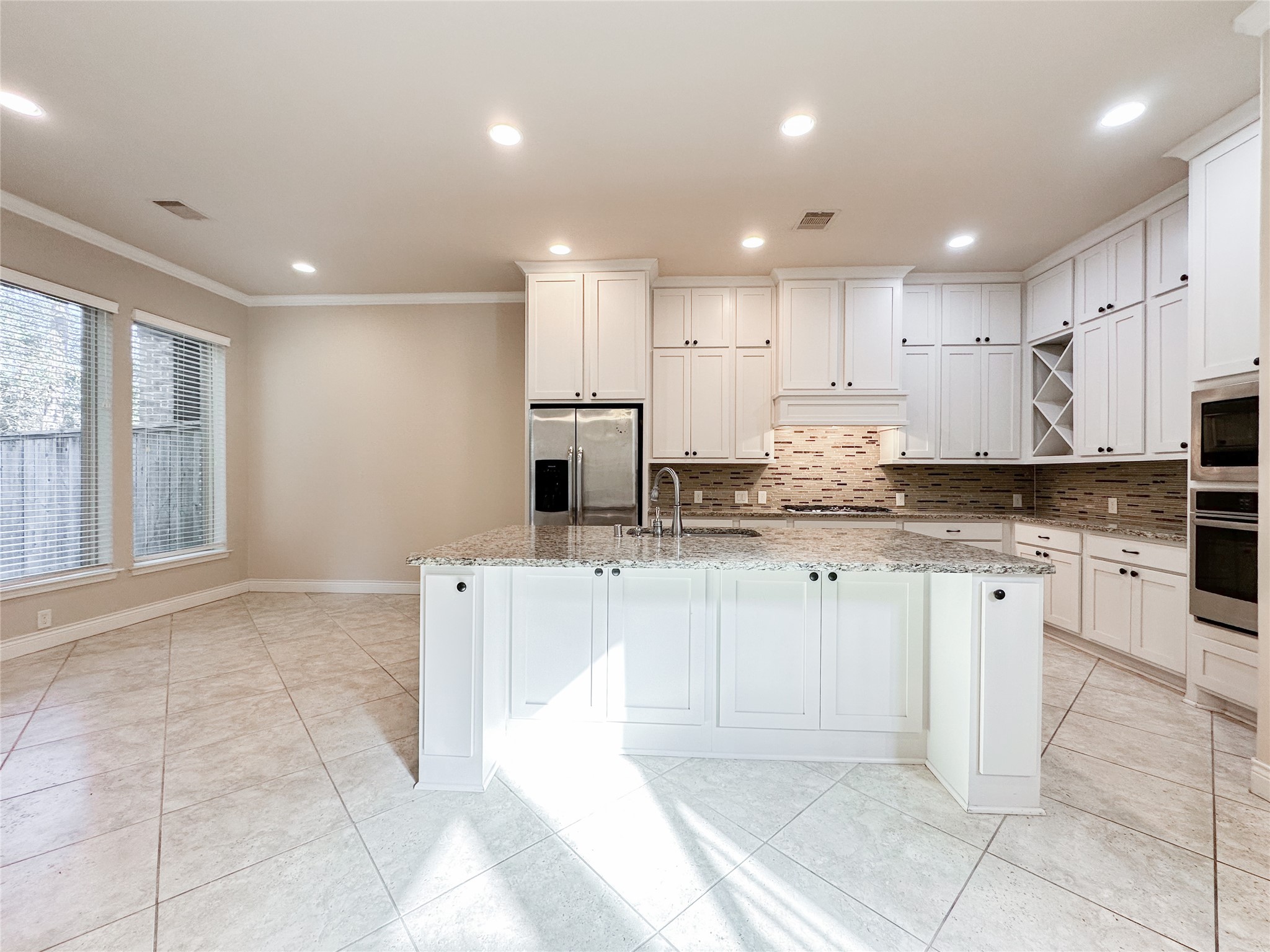 23 Jonquil Place Tomball, TX 77375 - Photo 18 of 50 a kitchen with stainless steel appliances granite countertop a sink and cabinets