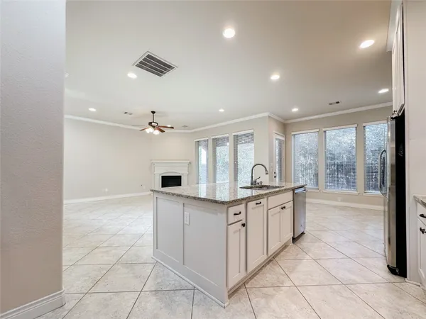 a kitchen with granite countertop a sink and cabinets
