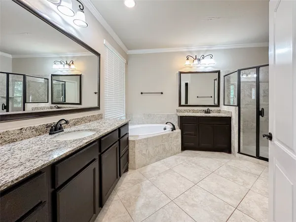 a spacious bathroom with a granite countertop sink and a mirror