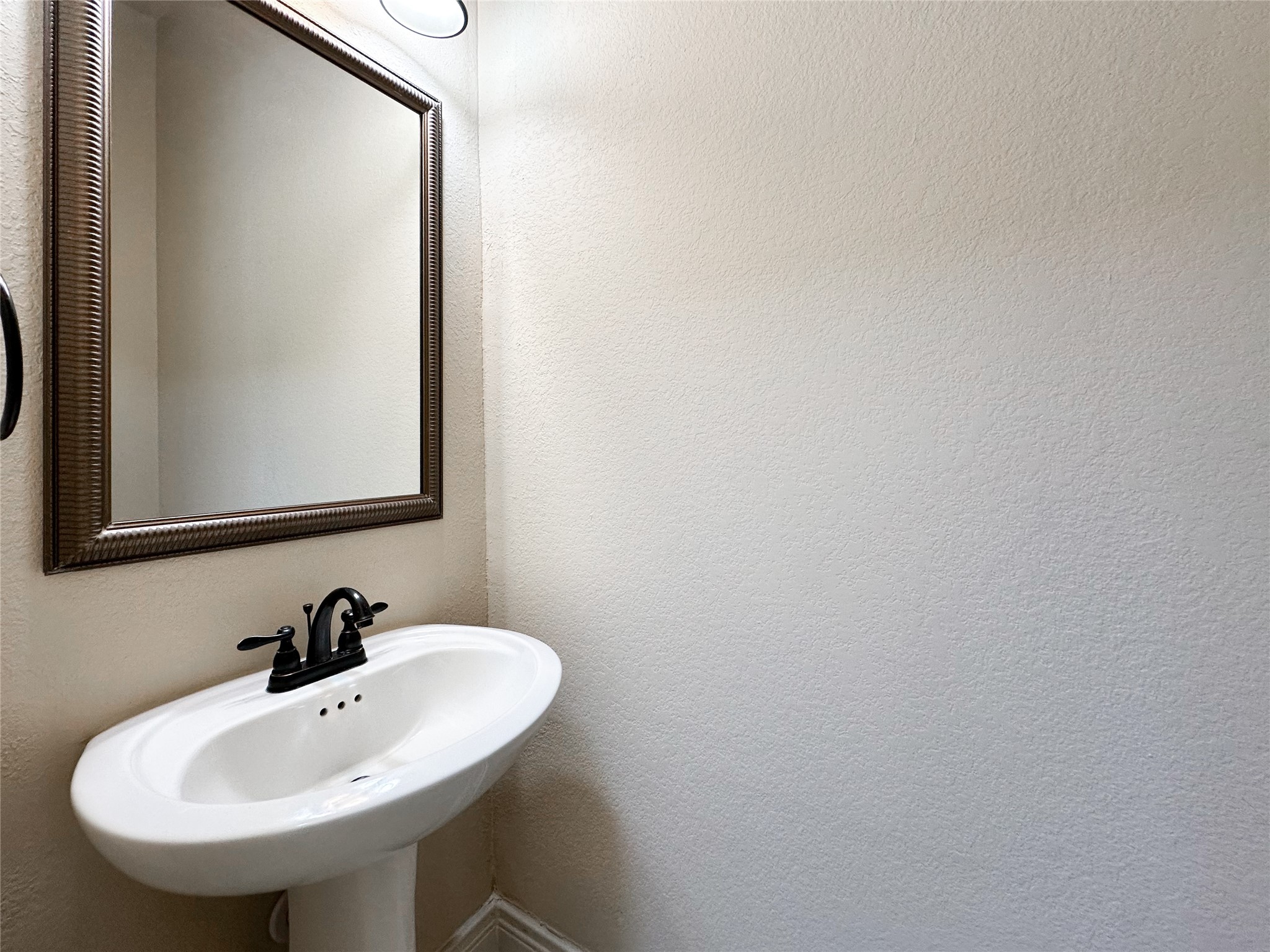 23 Jonquil Place Tomball, TX 77375 - Photo 44 of 50 a bathroom with a sink and a mirror