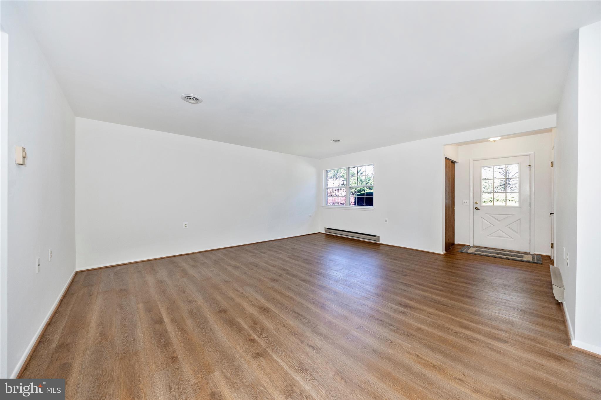 5738 Box Elder Court Frederick, MD 21703 - Photo 5 of 50 an empty room with wooden floor and windows