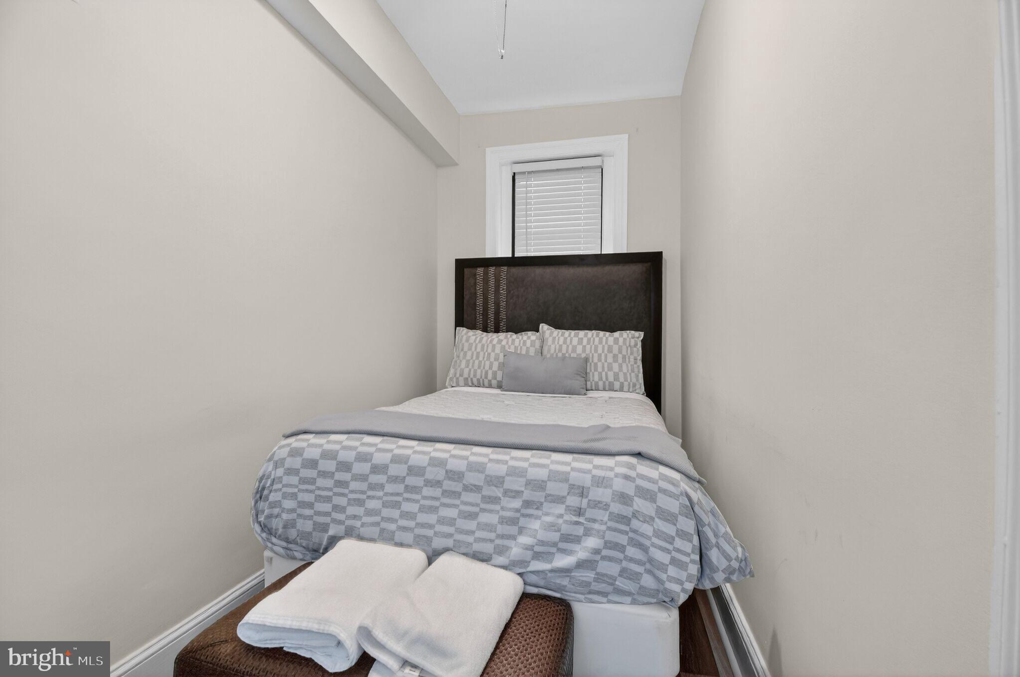 1919 19th Street Northwest, Unit 302 Washington, DC 20009 - Photo 15 of 16 a bed sitting in a bedroom next to a small yard