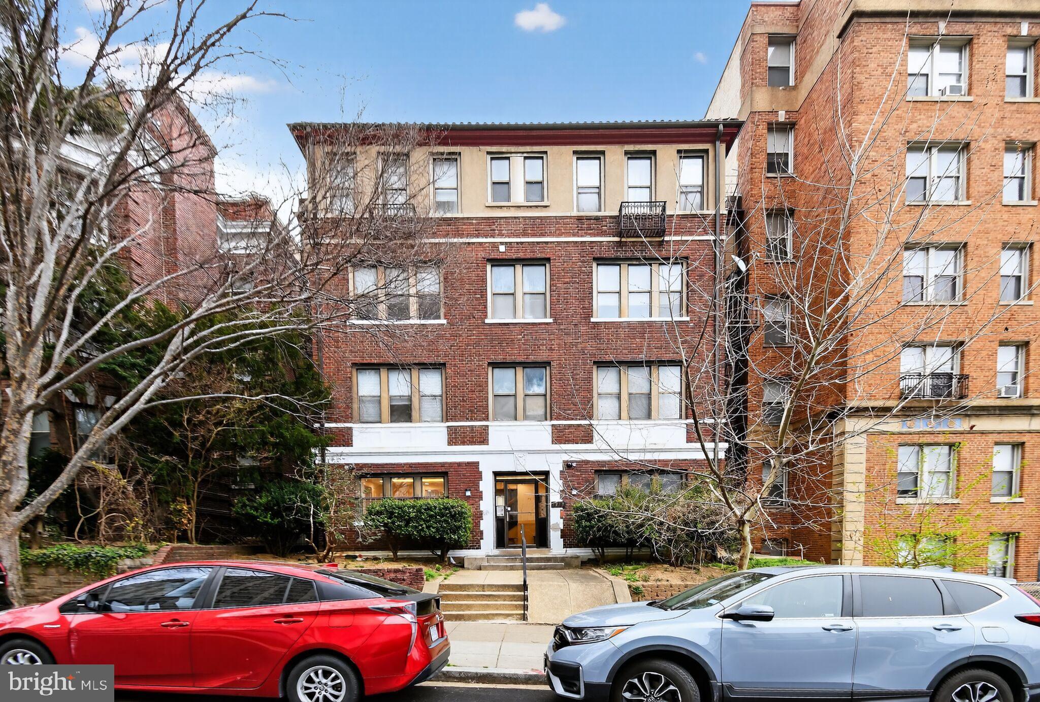 1919 19th Street Northwest, Unit 302 Washington, DC 20009 - Photo 16 of 16 a front view of a residential apartment building with a yard