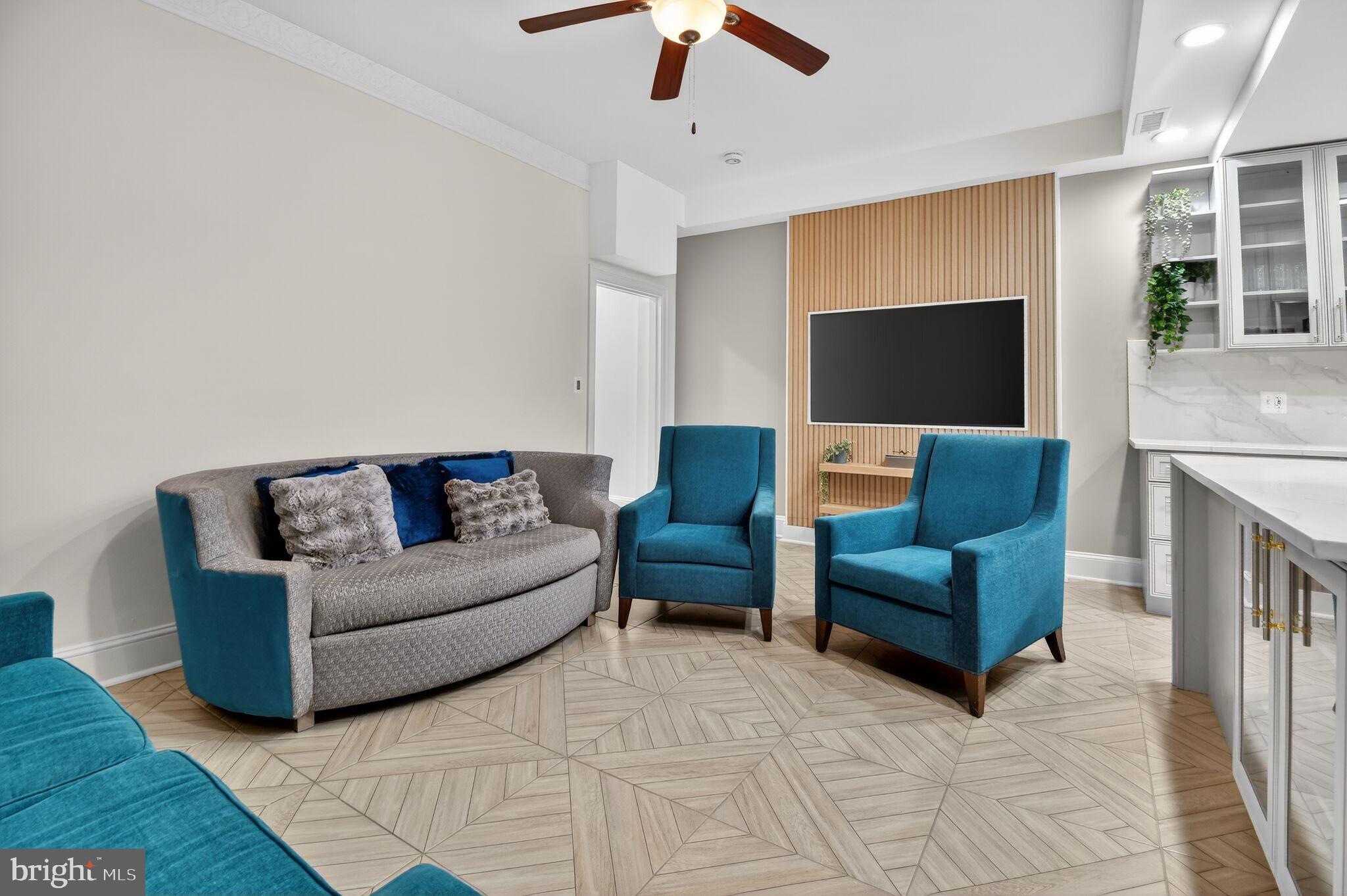 1919 19th Street Northwest, Unit 302 Washington, DC 20009 - Photo 2 of 16 a living room with furniture and a flat screen tv