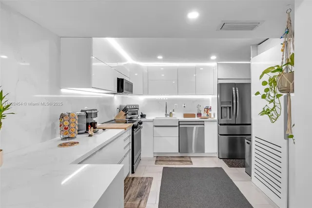 a kitchen with a refrigerator and a sink