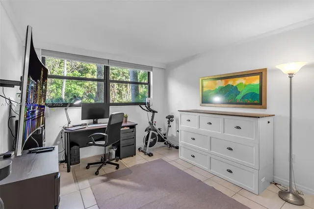 a view of a livingroom with workspace and a window