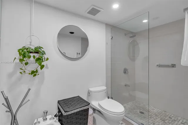 a bathroom with a toilet sink and shower