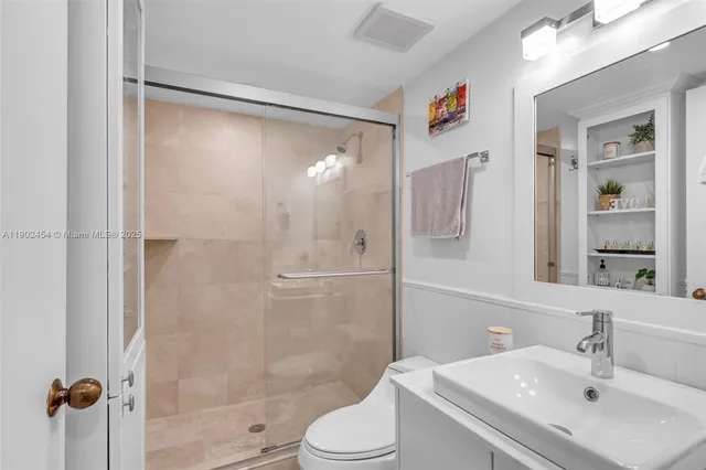 a bathroom with a sink toilet and shower