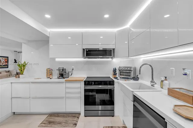 a kitchen with a sink a stove and cabinets