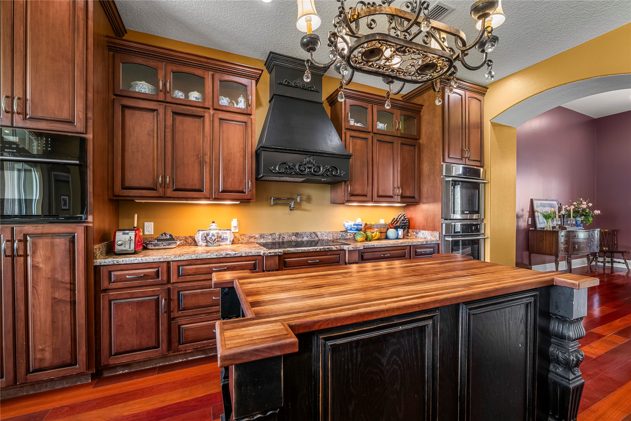 27247 Hallman Road Hilliard, FL 32046 - Photo 24 of 59 a kitchen with stainless steel appliances granite countertop a stove and a wooden cabinets