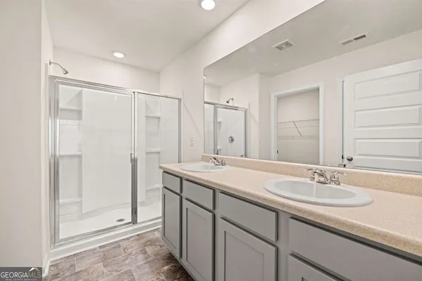 a bathroom with double sink and a mirror