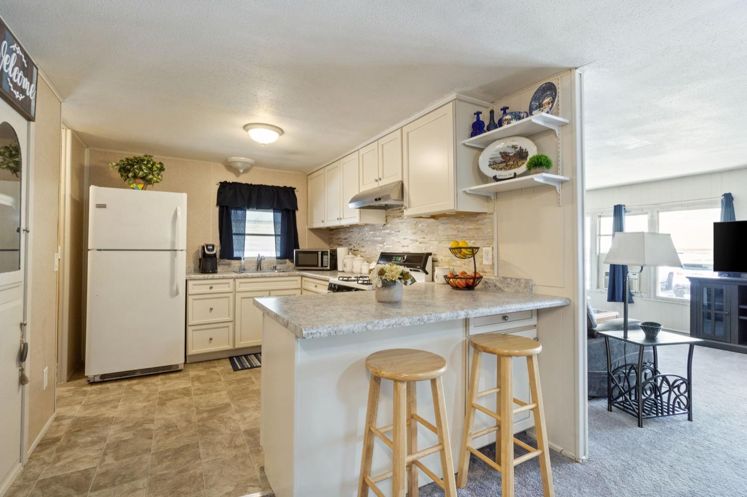1500 Villa Avenue Clovis, CA 93612 - Photo 9 of 28 a kitchen with refrigerator and cabinets