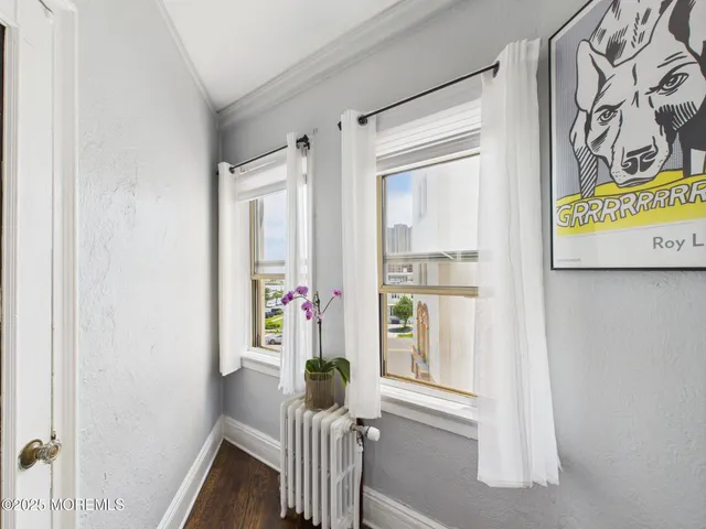 a view of hallway with furniture and a window