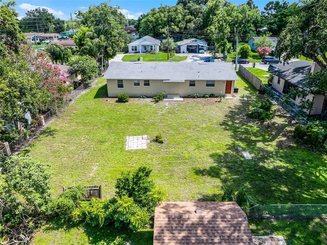 an aerial view of residential houses with outdoor space and street view