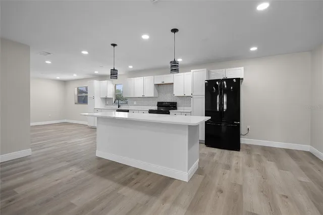 a kitchen with stainless steel appliances a refrigerator sink and cabinets