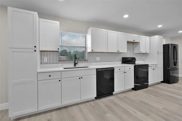 a kitchen with stainless steel appliances a refrigerator sink and cabinets