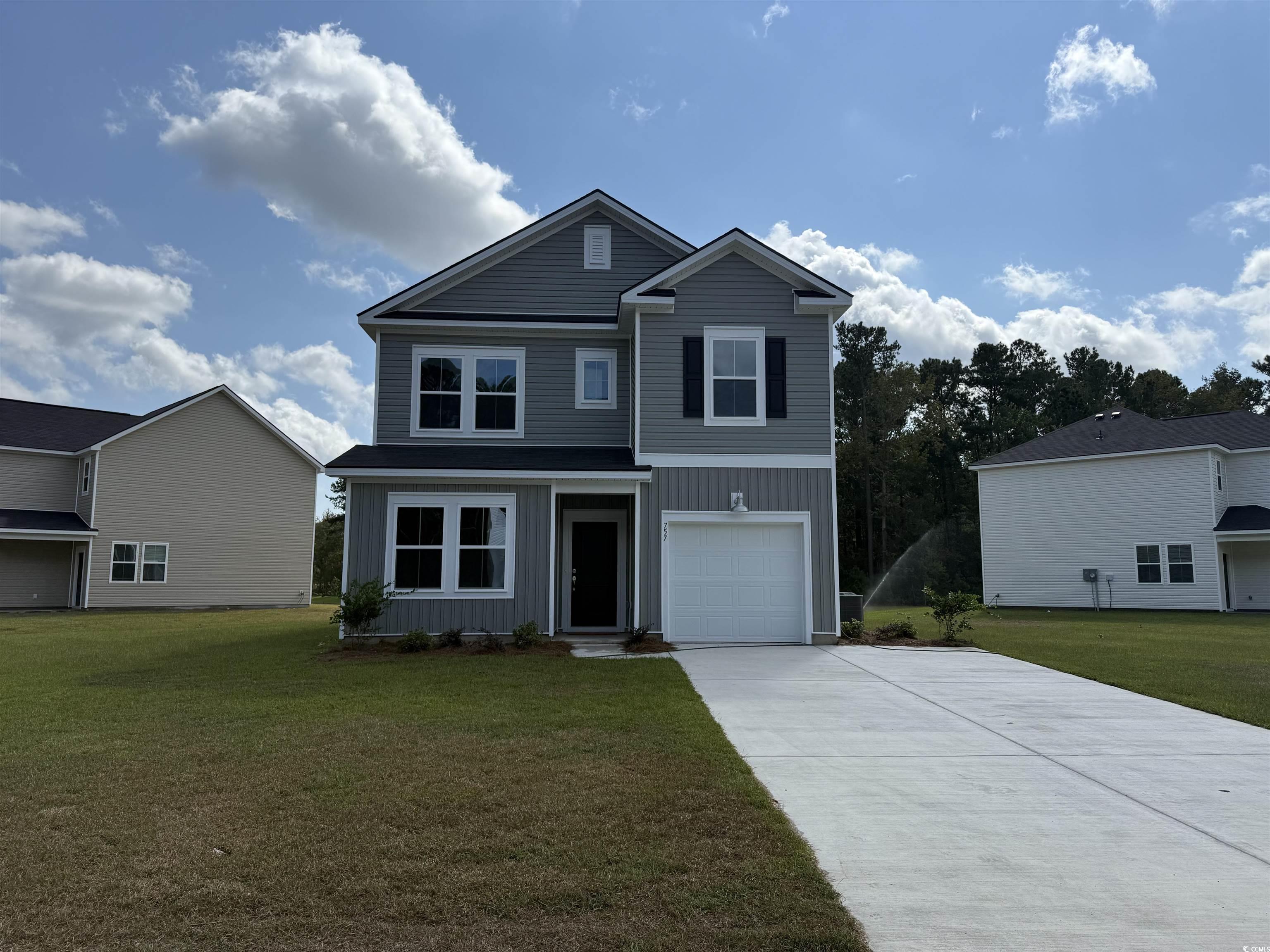 757 Sturdy Root Place Myrtle Beach, SC 29588 - Photo 1 of 14 Traditional home featuring driveway, a front yard, a garage, and board and batten siding