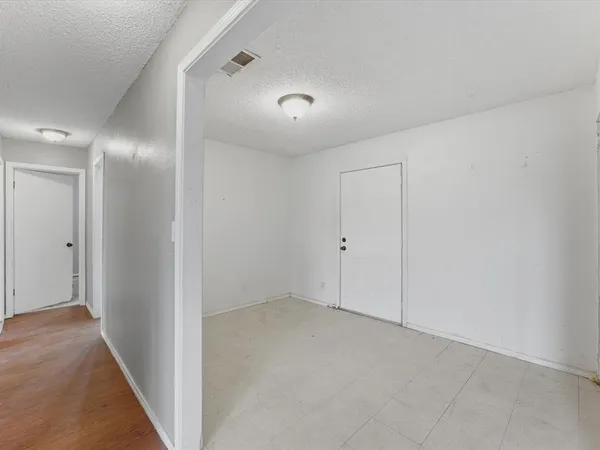 an empty room with furniture and a fireplace