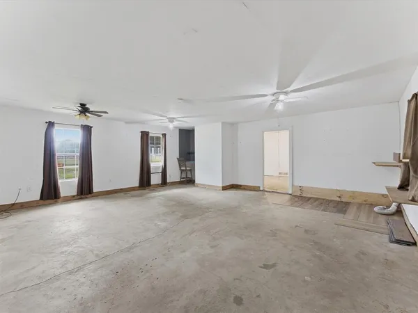 a view of hallway with shower and wooden floor