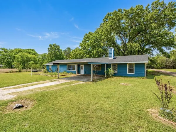 a front view of house with yard and swimming pool