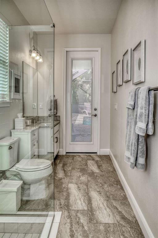 11539 Tapestry Lane Venice, FL 34293 - Photo 11 of 21 a bathroom with a sink a toilet and a mirror
