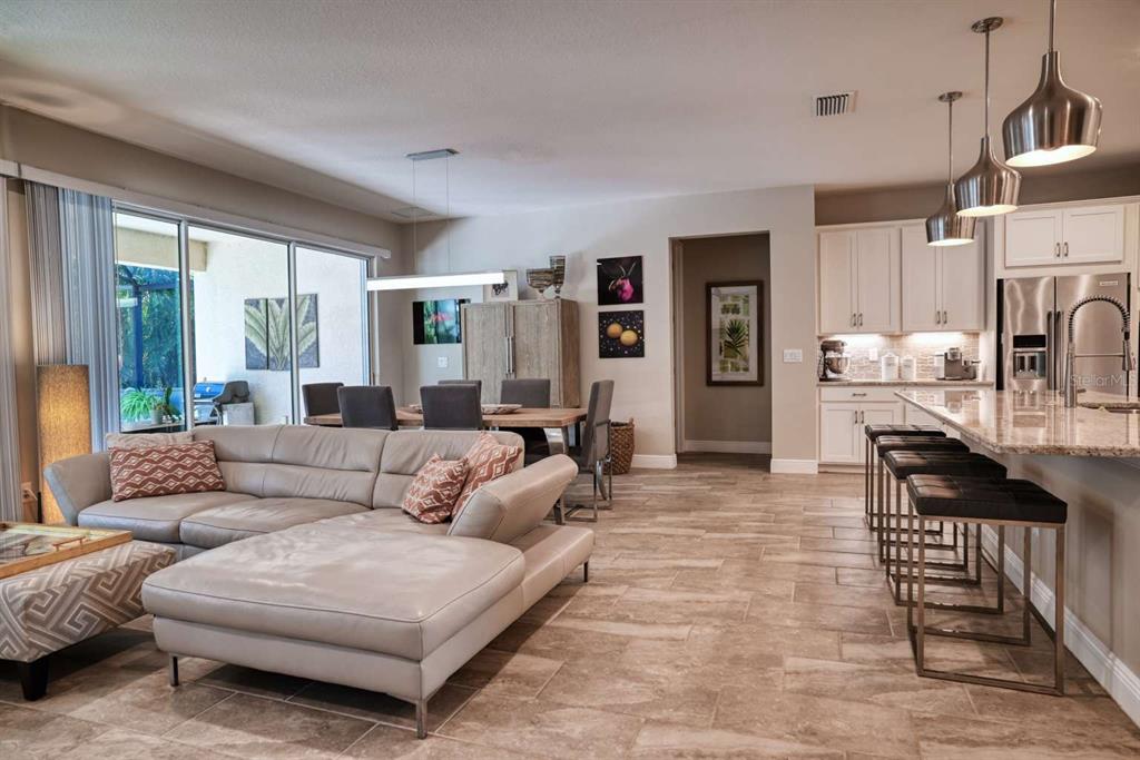 11539 Tapestry Lane Venice, FL 34293 - Photo 15 of 21 a living room with furniture and a fireplace