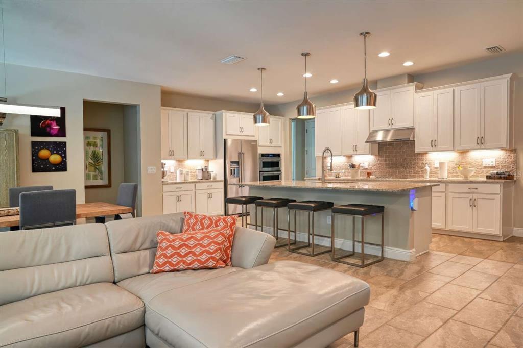 11539 Tapestry Lane Venice, FL 34293 - Photo 16 of 21 a living room with stainless steel appliances kitchen island granite countertop furniture and a view of kitchen