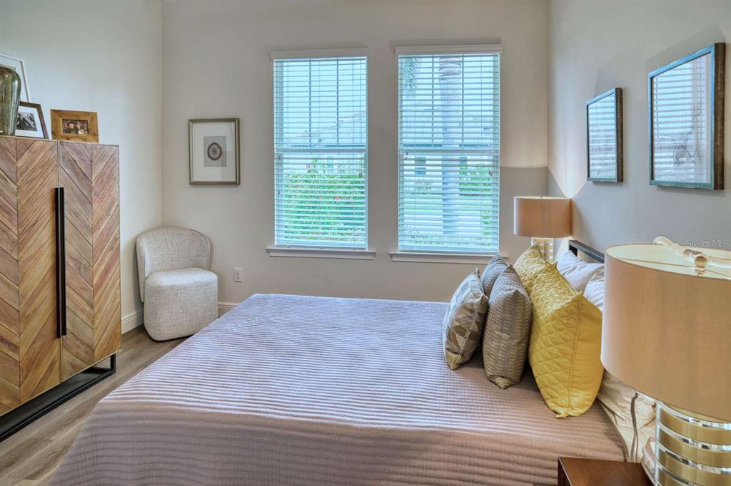 11539 Tapestry Lane Venice, FL 34293 - Photo 7 of 21 a bedroom with a bed and a chair