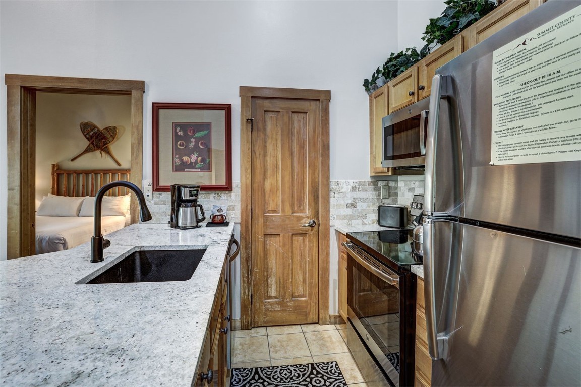 91 River Run Road, Unit 8134 Keystone, CO 80435 - Photo 11 of 30 a kitchen with a refrigerator and a sink