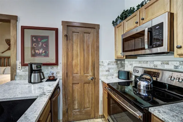 a spacious bedroom with a bed and a flat screen tv