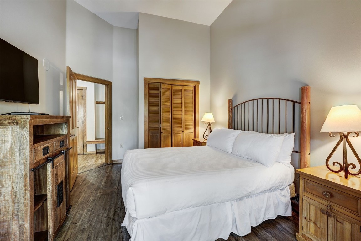 91 River Run Road, Unit 8134 Keystone, CO 80435 - Photo 14 of 30 a bedroom with a bed a flat screen tv and dresser