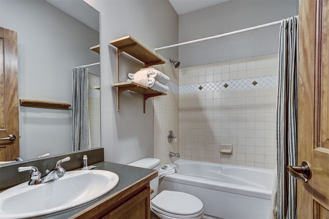 91 River Run Road, Unit 8134 Keystone, CO 80435 - Photo 15 of 30 a bathroom with a granite countertop sink toilet and shower