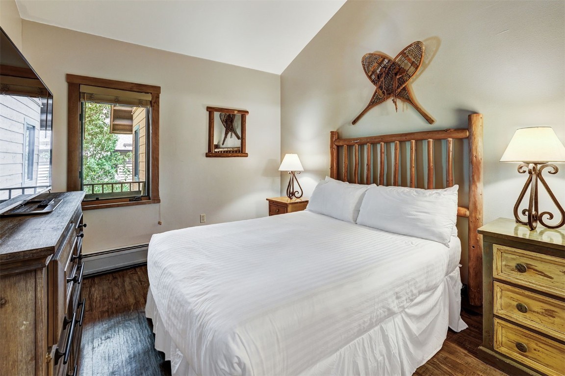 91 River Run Road, Unit 8134 Keystone, CO 80435 - Photo 16 of 30 a bedroom with a bed and a dresser next to a window
