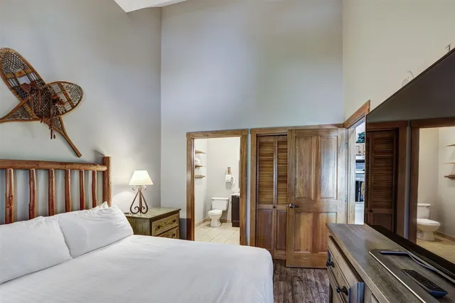 a bathroom with a bath tub sink mirror and vanity