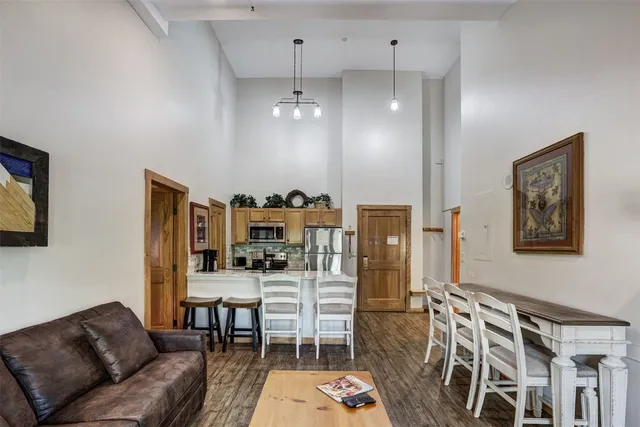 a dining room with furniture and wooden floor