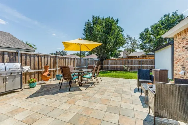 a view of a chairs and tables in the back yard of the house