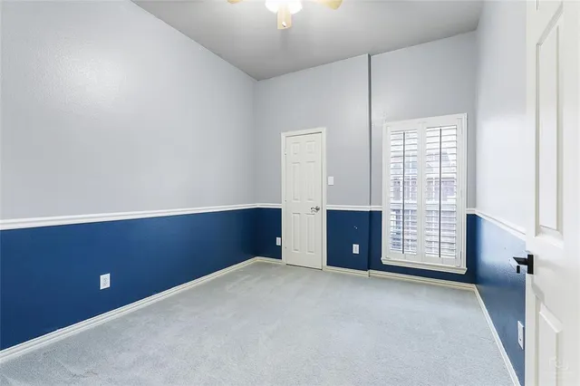 an empty room with windows and cabinet
